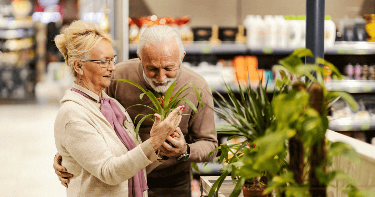 Senior couple sopping looking for decorating items for senior living.
