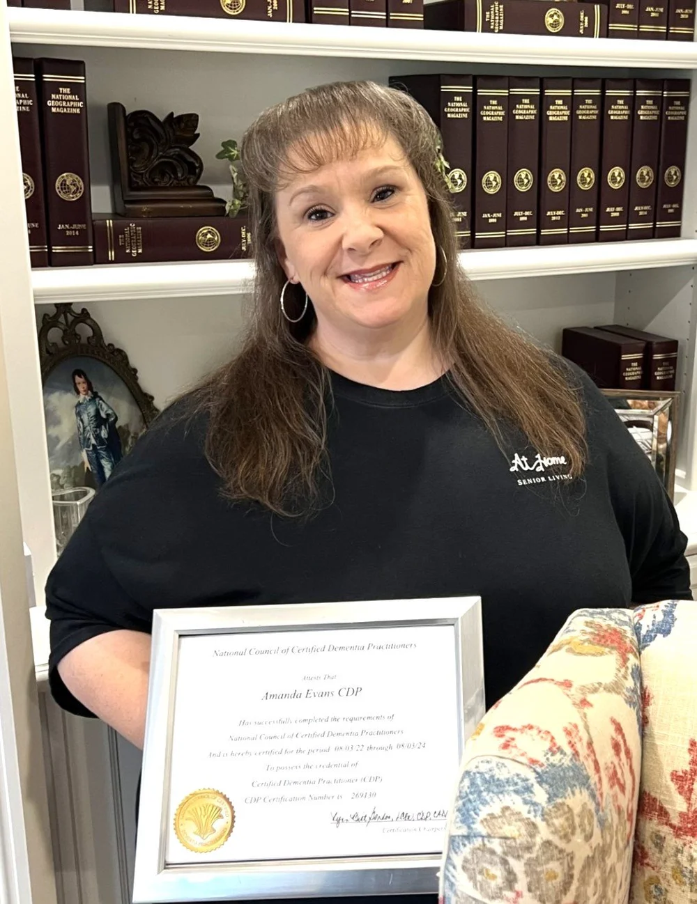 Headshot of Amanda Evans with a certificate