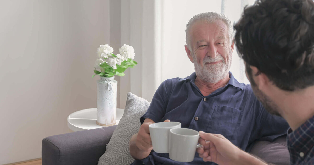 5 Ways to Help Your Loved One Feel at Home When Moving to Assisted Living Two men drinking coffee on the sofa