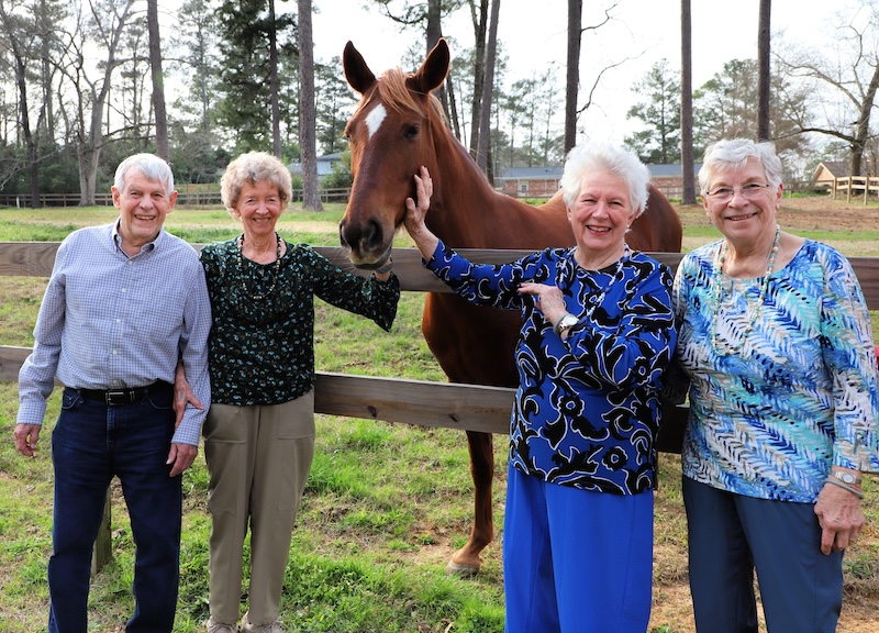 Seniors with a horse on a farm